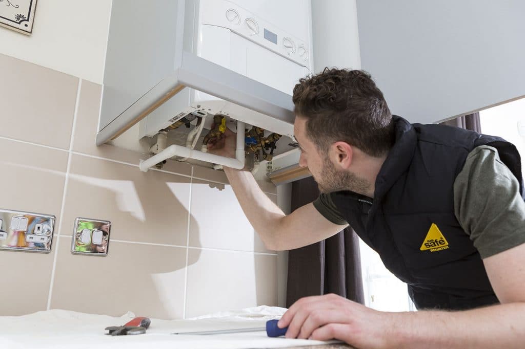Plumber repairing pipework