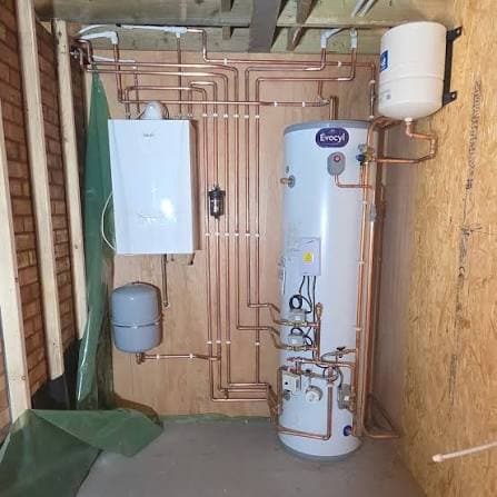 Engineer working on an unvented hot water cylinder